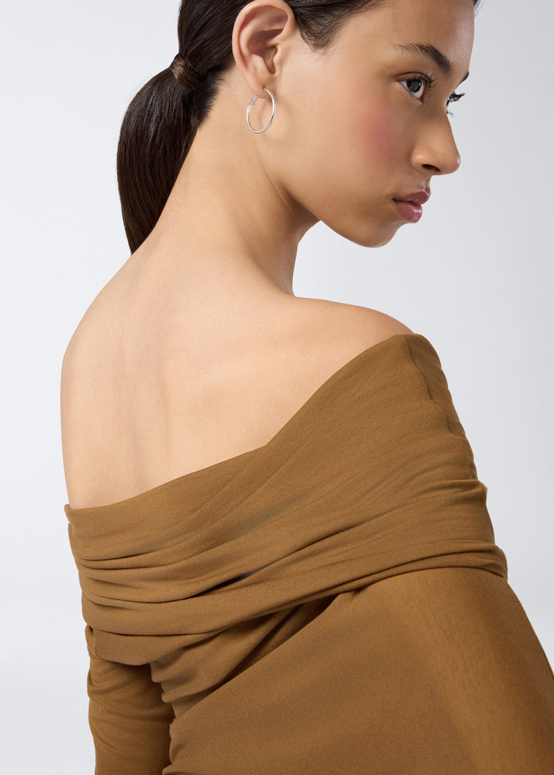 
                          Detail view of Zoe Mini Dress showing adaptable off-shoulder neckline in soft brown jersey fabric, highlighting the textured draping and long sleeves.
                        
