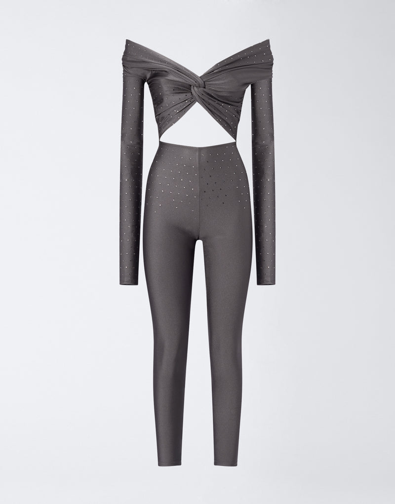
                          Frontal view shows Kendall Crystal Jumpsuit in ardesia shiny lycra, off-the-shoulder with knot detail, chest cut-out, crystal embellishments, and full-length leggings.
                        