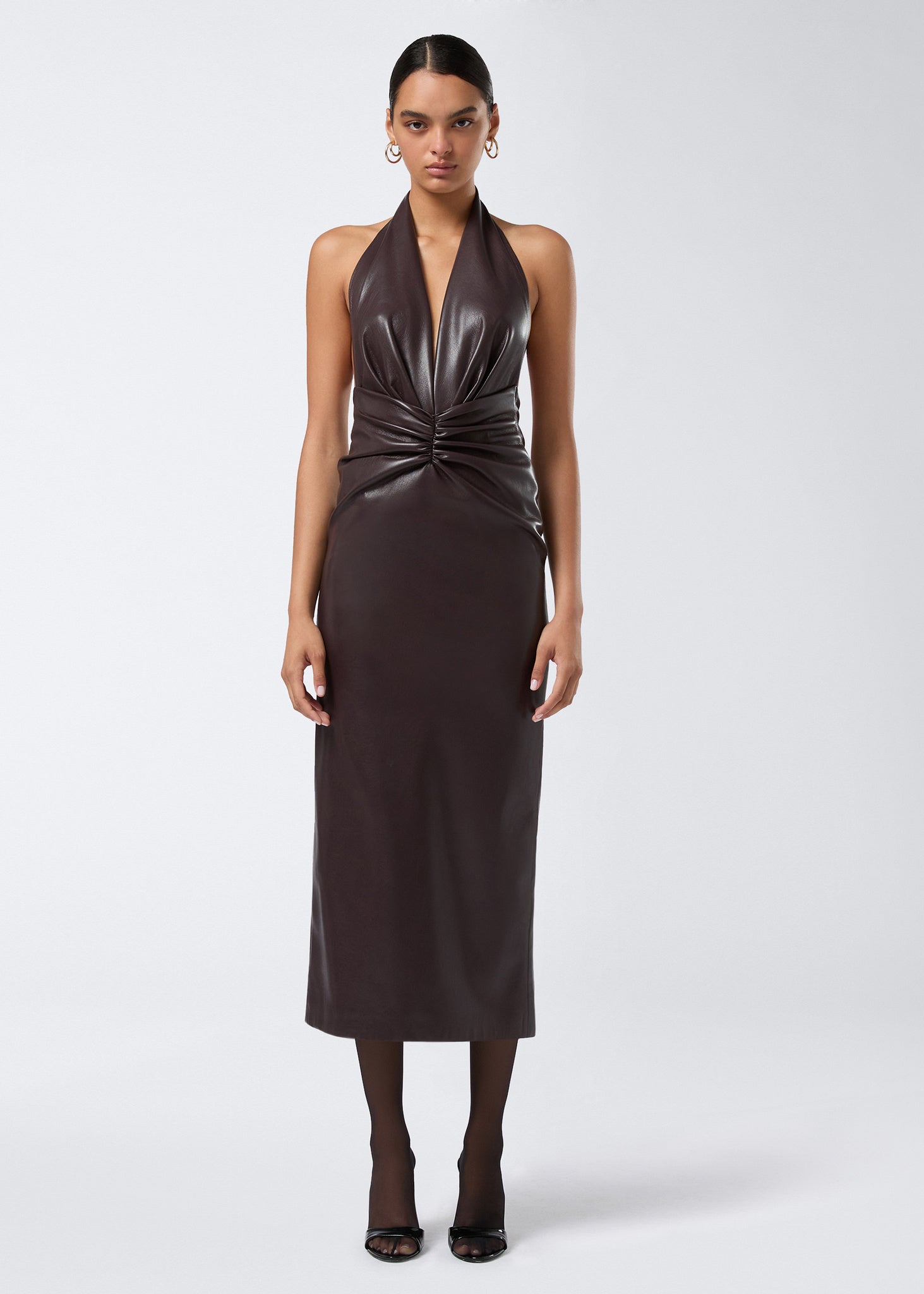 Frontal view of the Zendaya Midi Dress in cabernet vegan leather, featuring a plunging V-neck with halterneck straps, ruching at the waist, and a sleek midi silhouette.
