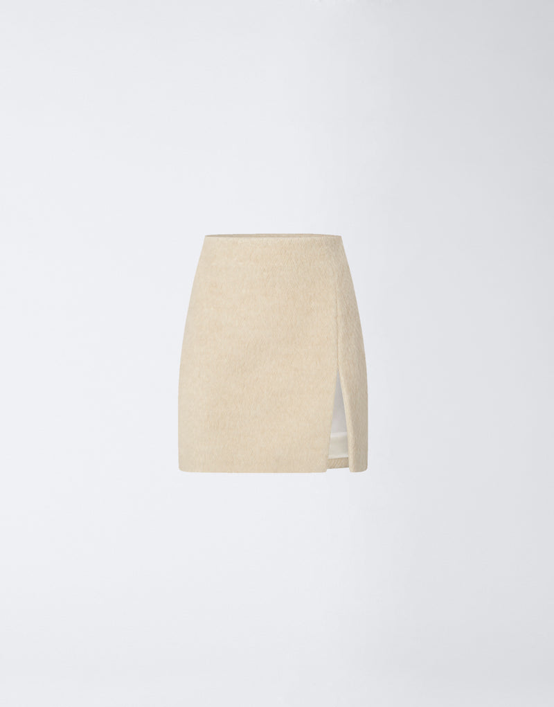 
                          Frontal view of the Gioia Mini Skirt in soft ivory wool twill, featuring a high-waisted fit, side thigh slit, and clean minimalist design.
                        