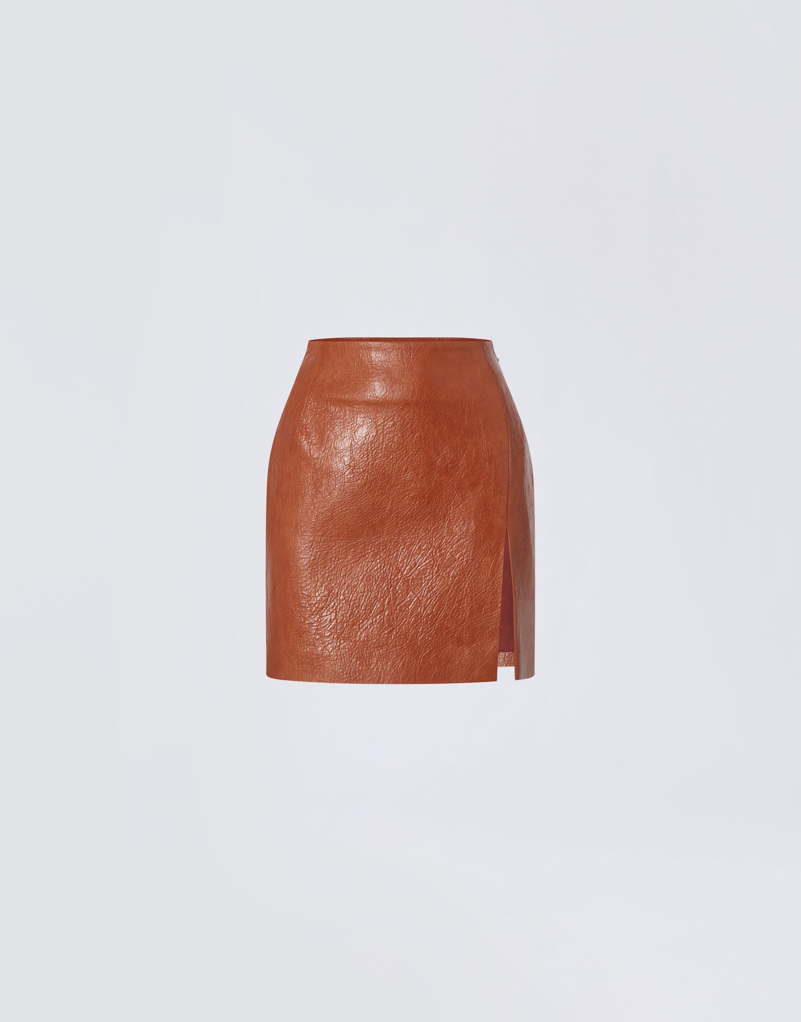 Frontal view shows the Gioia Mini Skirt in cuoio embossed eco leather with high waist, thigh slit, and sleek, structured design.
