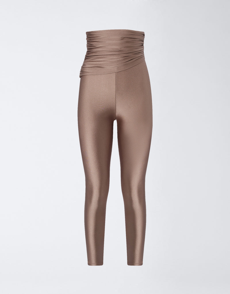 
                          Frontal view of Vicky Leggings in a greige shiny lycra, featuring a high waist with draped fabric detail and full-length stretch fit.
                        