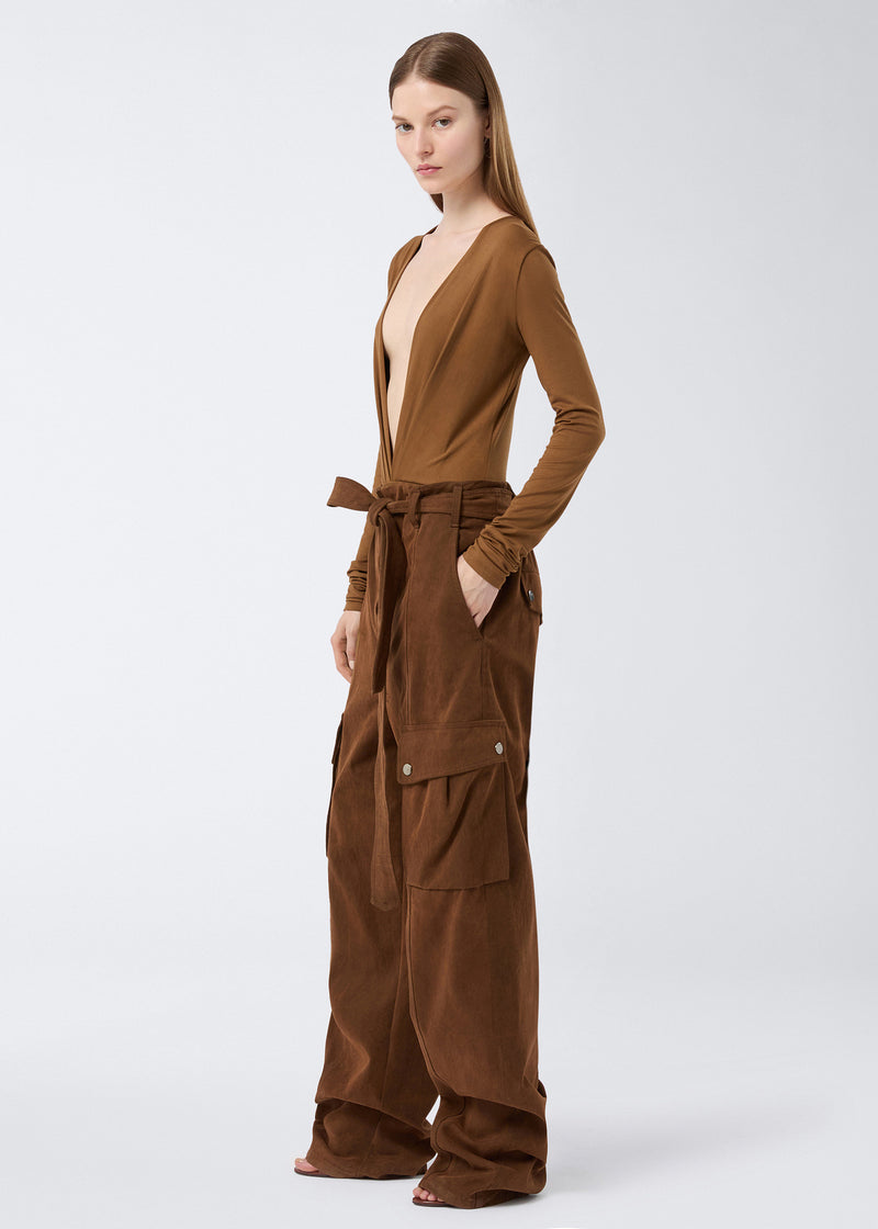 
                          Side view of a woman wearing Xandra Maxi Pants in cigar-colored, stone-washed cotton with large patch pockets, a belted waist, and wide legs.
                        