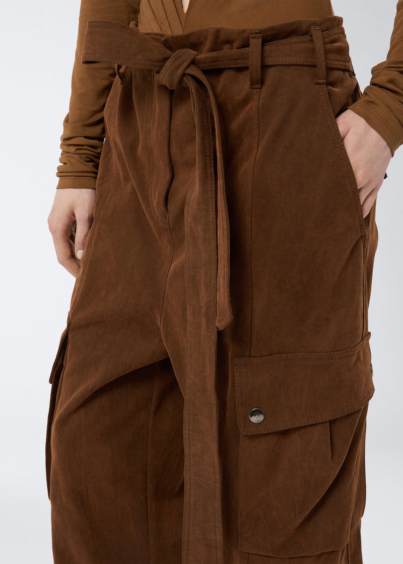 
                          Frontal detail view of Xandra Maxi Pants showing cigar-colored, stone-washed cotton fabric, front tie belt, patch cargo pocket with snap button, and side hand placement.
                        