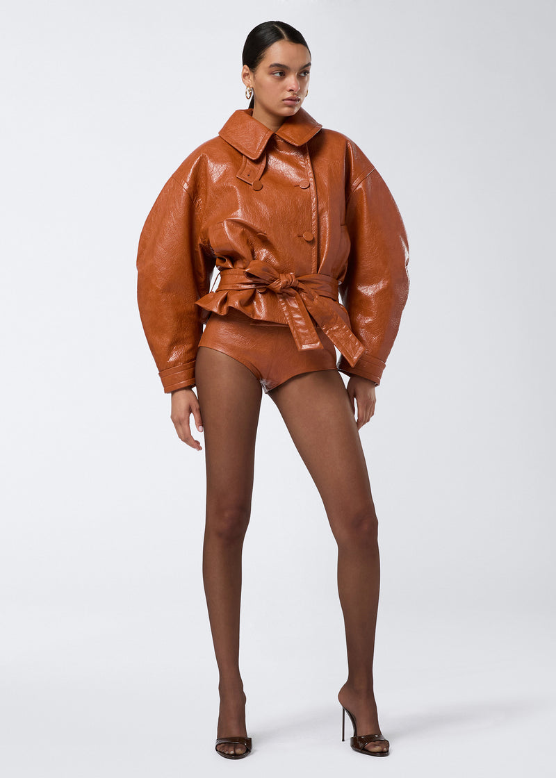 
                          Frontal view of a model wearing Tami Culottes in cuoio embossed eco-leather, featuring a high waist and side zip, styled with a matching oversized jacket.
                        