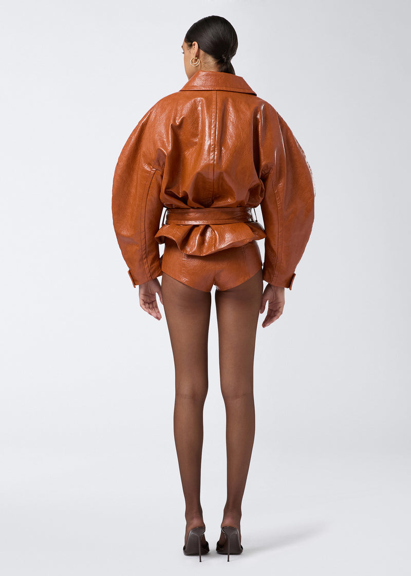 
                          Rear view of a model wearing Tami Culottes in cuoio embossed eco-leather, featuring a high-waist, side zip fastening, paired with matching oversized jacket.
                        