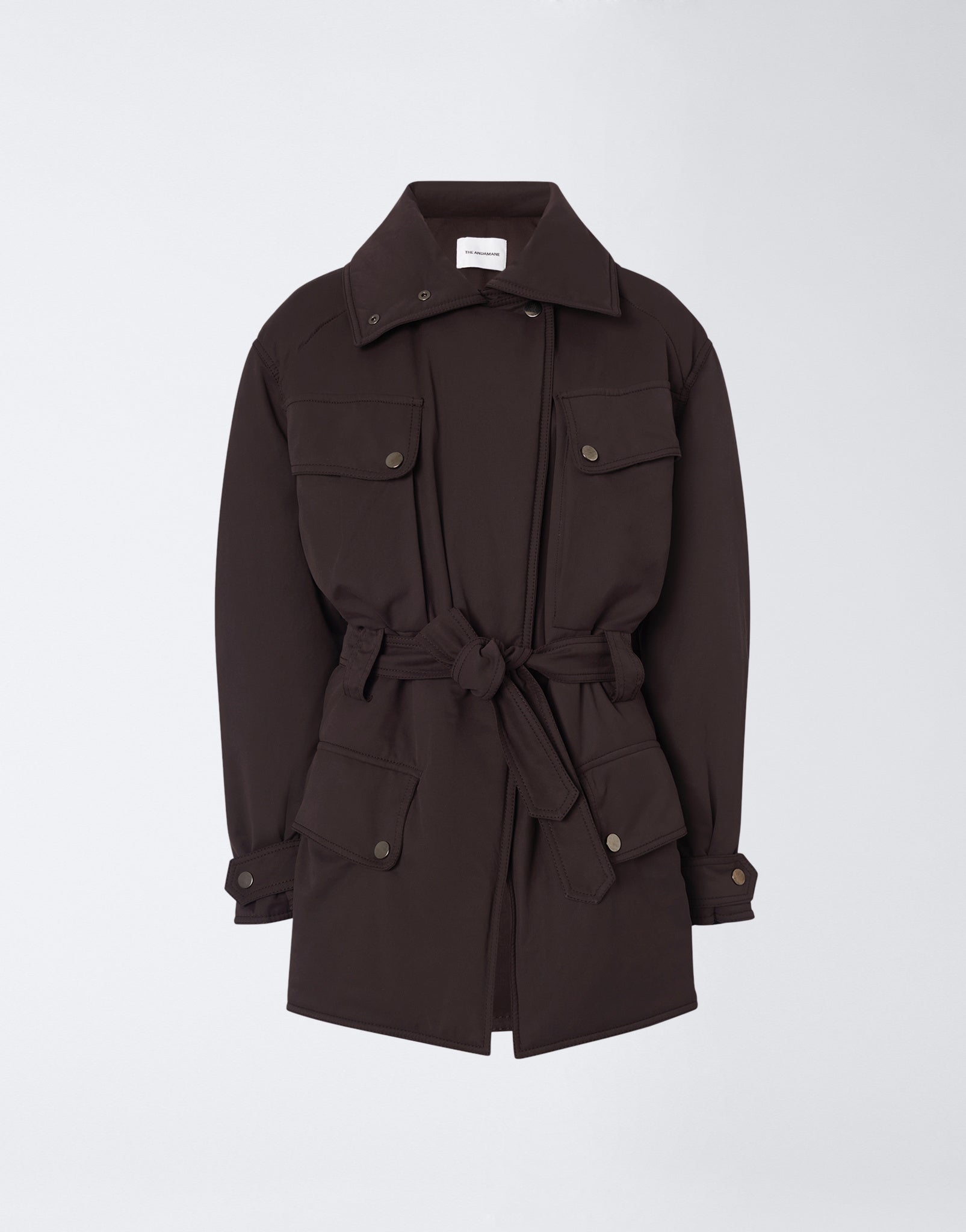 Frontal view. Xandra Jacket in dark brown structured suede-touch nylon, oversized spread collar, matching belt at back, four buttoned flap pockets, buttoned cuffs.