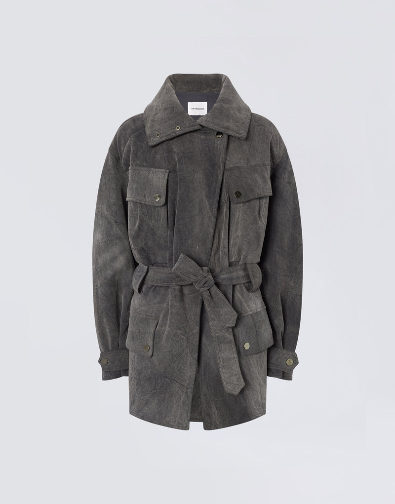 
                          Frontal view of Xandra Jacket in ardesia stone-washed cotton with oversized spread collar, belted waist, button flap pockets, and buttoned cuffs.
                        