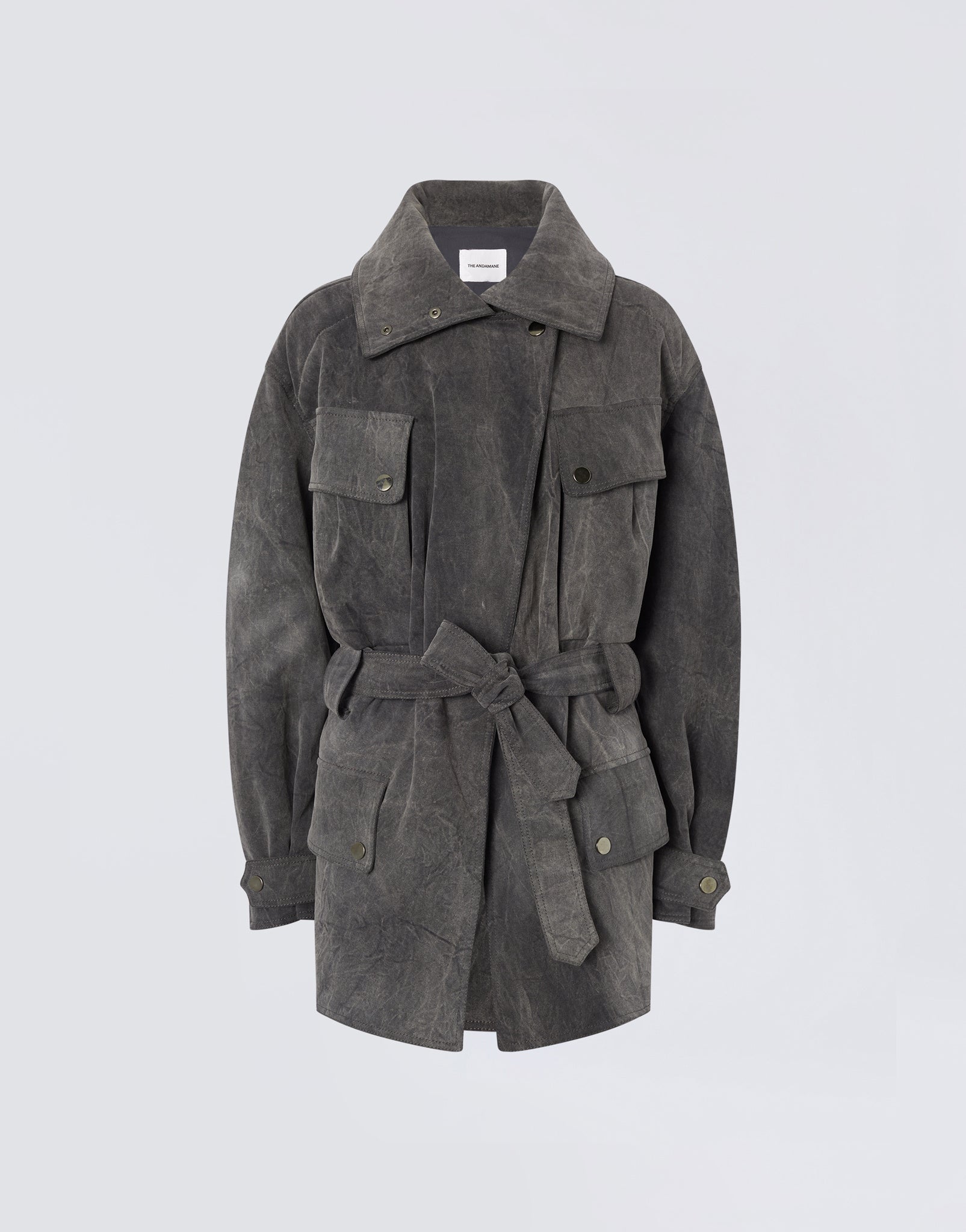 Frontal view of Xandra Jacket in ardesia stone-washed cotton with oversized spread collar, belted waist, button flap pockets, and buttoned cuffs.