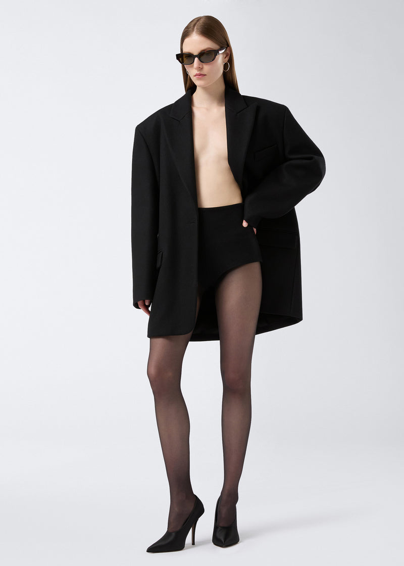 
                          Frontal view shows a model wearing the Teresa Blazer, an oversized black felted wool single-breasted blazer with peaked lapel, pockets, and button closure.
                        