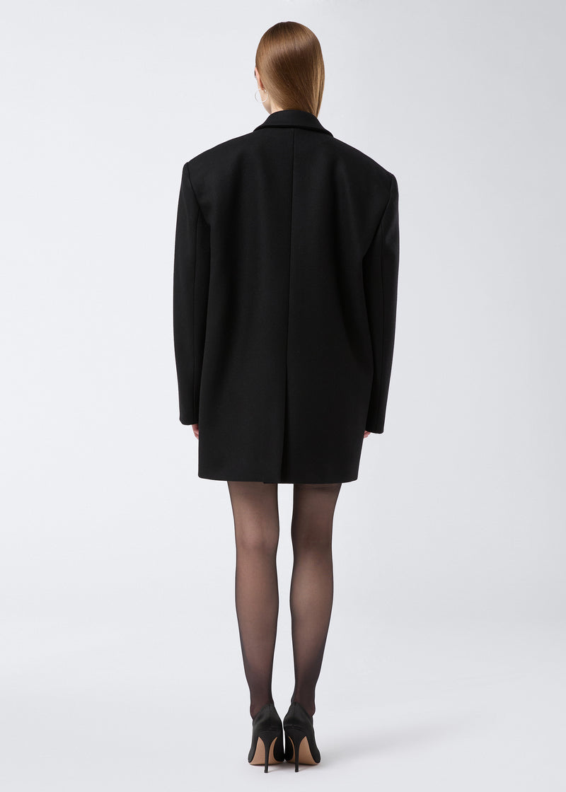 
                          Rear view showing a model wearing the Teresa Blazer in black felted wool, displaying an oversized fit with a back vent detail.
                        