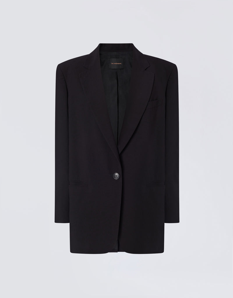 
                          Frontal view shows Teresa Blazer in black felted wool with single-breasted button closure, peaked lapel, visible front pockets, and label reading &#39;THE ANDAMANE&#39; inside collar.
                        