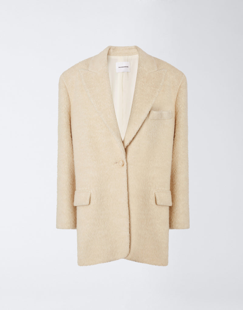 
                          Frontal view of the Teresa Blazer, an ivory oversized women&#39;s blazer made from soft wool twill, featuring peaked lapels, a single button closure, and flap pockets.
                        