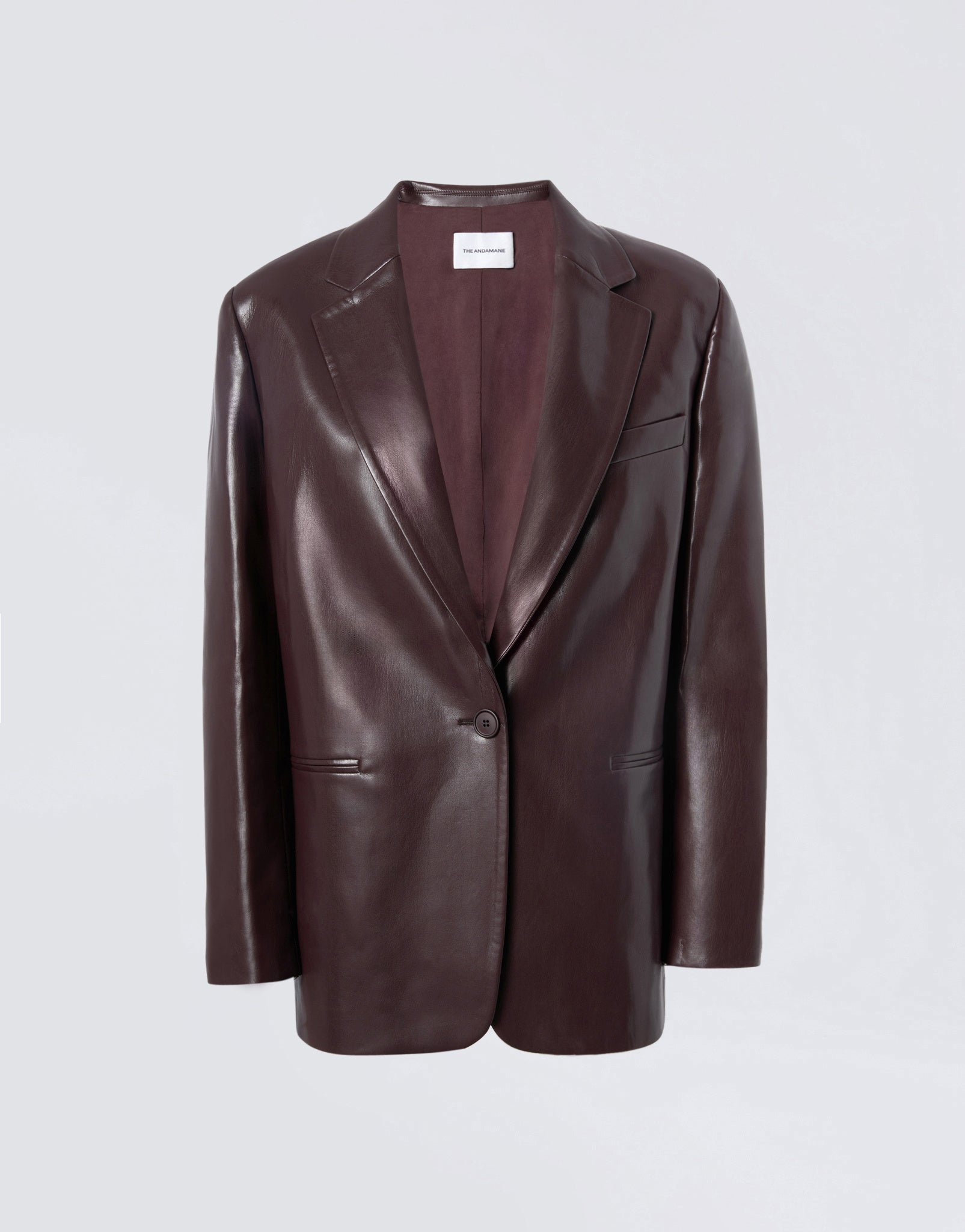 Frontal view of the Guia Blazer in cabernet vegan leather, showing its oversized, relaxed fit, notched lapel, single-breasted button closure, and welt chest pocket.
