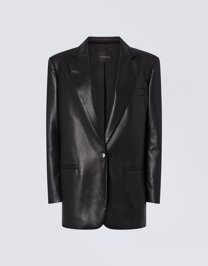 
                          Frontal view of the Guia Blazer, an oversized black vegan leather blazer featuring a notched lapel, single-breasted one-button closure, and welt pockets.
                        