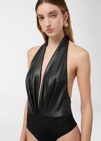 Frontal view of the Zendaya Bodysuit, a black vegan leather sleeveless bodysuit with a plunging halter-V-neck, structured front draping, and an open back.