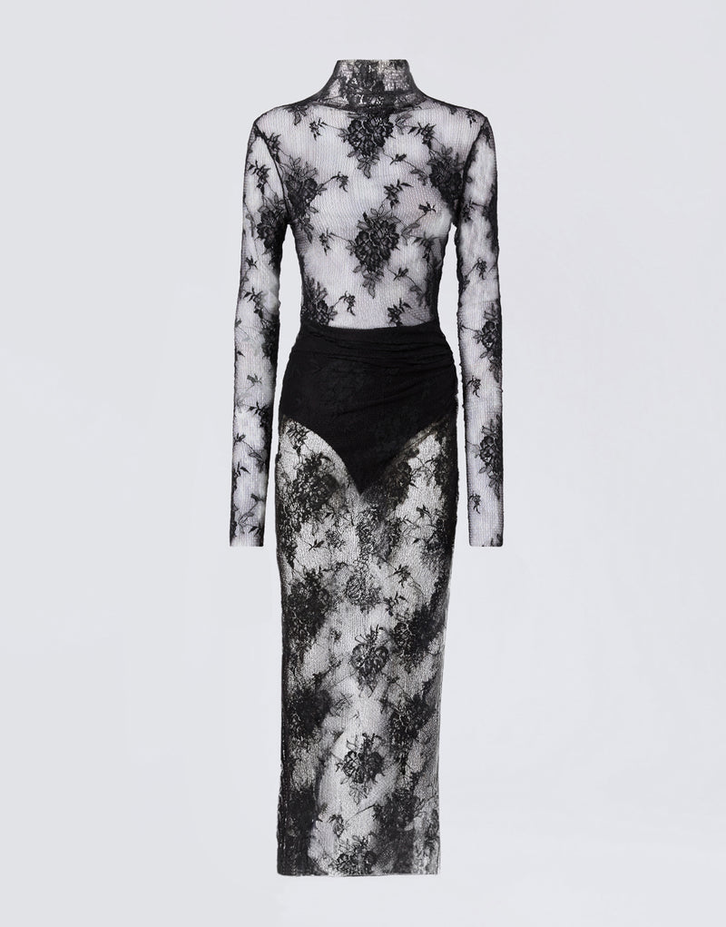 
                          Frontal view of the Tessa Jumpsuit, a sheer black lace jumpsuit with long sleeves, turtleneck, knot detail at the waist, and maxi skirt overlay.
                        
