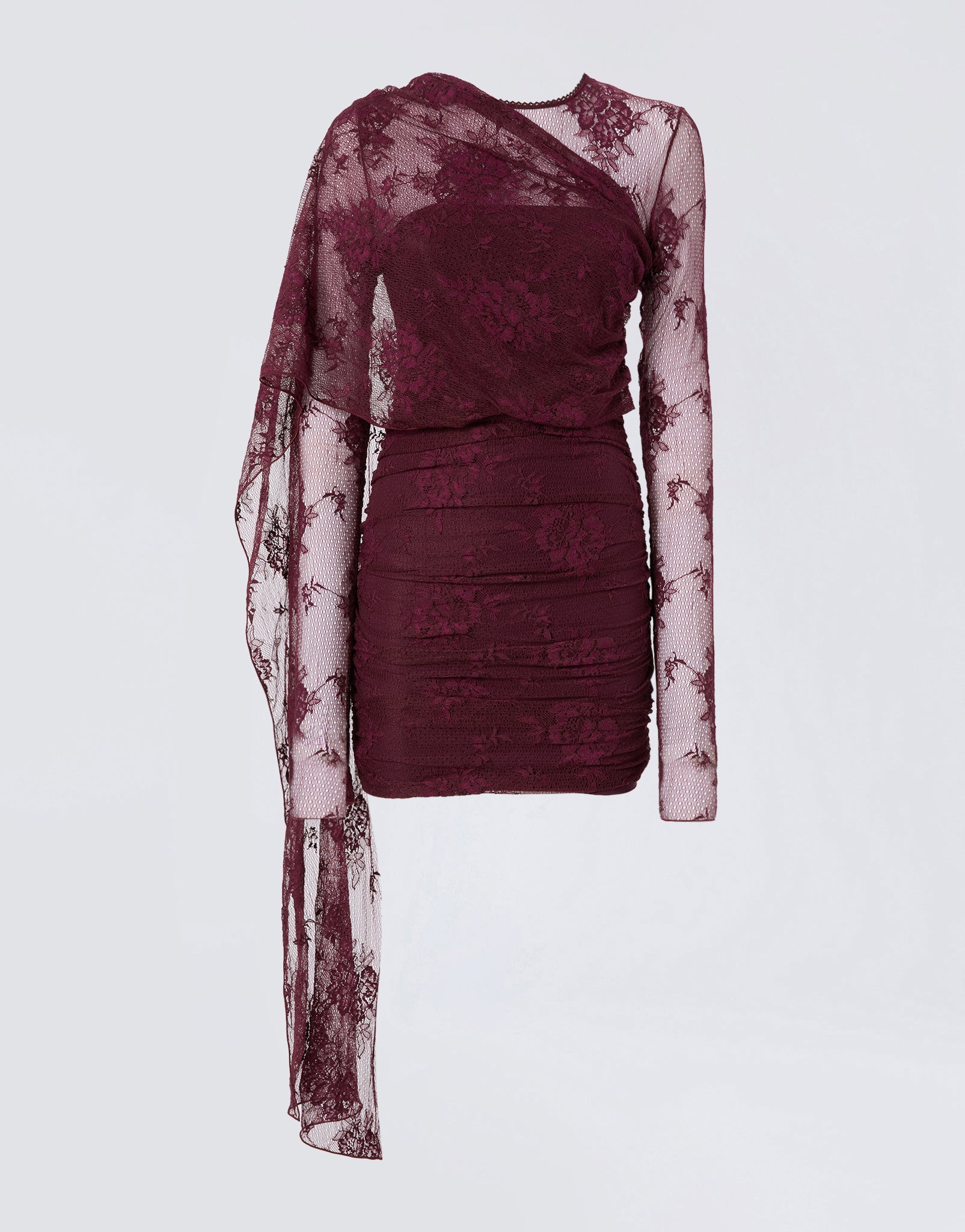 Frontal view of the Xenia Mini Dress in cabernet lace, featuring long sleeves, all-over ruching, built-in straps, and a dramatic cape cascading over one shoulder.