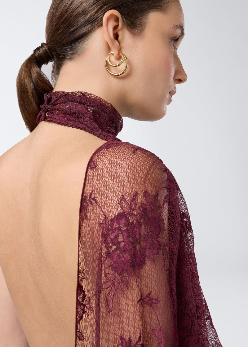 
                          Detail view of the Waverly Maxi Dress showing cabernet lace fabric, sheer floral pattern, high turtleneck collar, and cape draping over shoulder and back.
                        