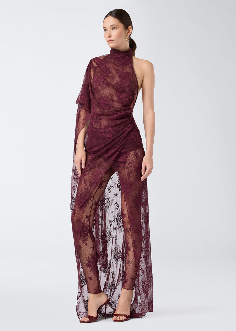 
                          Frontal view of the Waverly Maxi Dress, showcasing its sheer cabernet lace fabric, cape-effect draping over one shoulder, turtleneck, floor-length design, and side leg slit.
                        
