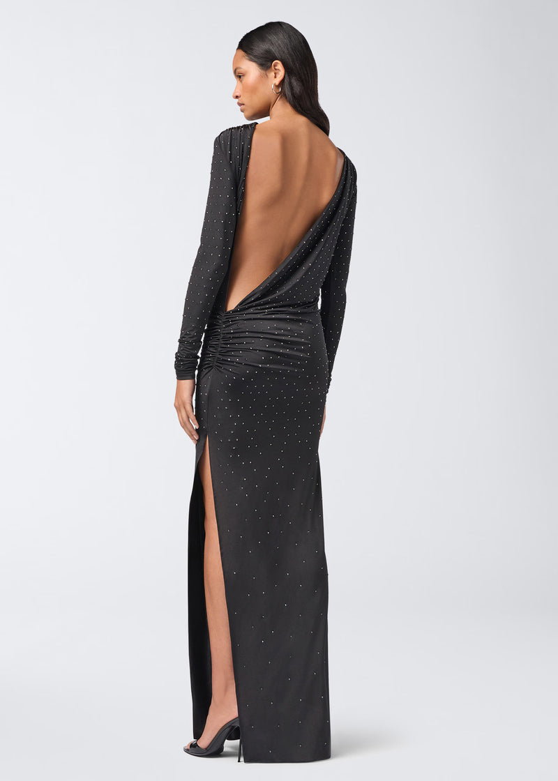 
                          Rear view: Model wears Sophie Maxi Crystal Dress, a black, long-sleeved, floor-length dress with all-over crystals, open draped back, and side ruching.
                        