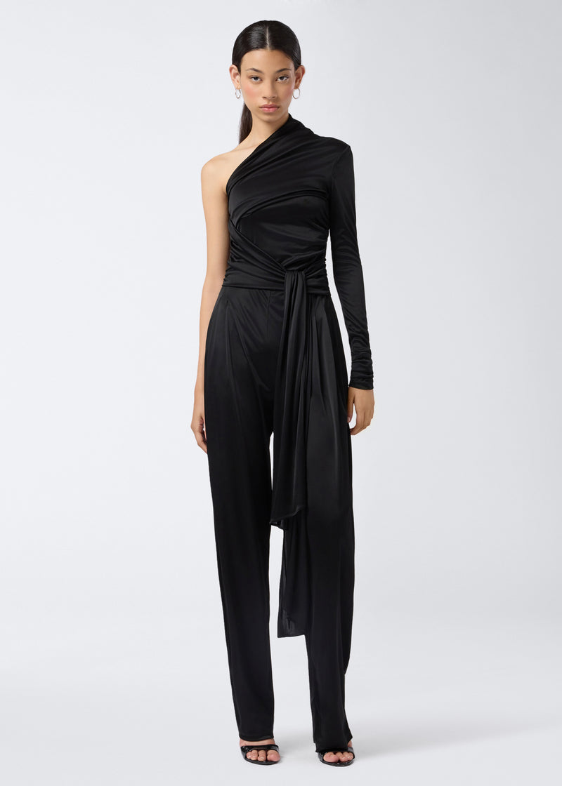 
                          Frontal view of the Webster Jumpsuit, a black shiny jersey one-shoulder jumpsuit with a long sleeve on one side, tonal waist belt, and straight-leg pants.
                        
