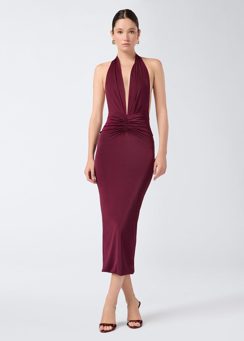 
                          Frontal view of the Zendaya Midi Dress in a cabernet lightweight jersey, featuring a halterneck strap, deep plunging V-neck, and ruched waist accentuation.
                        