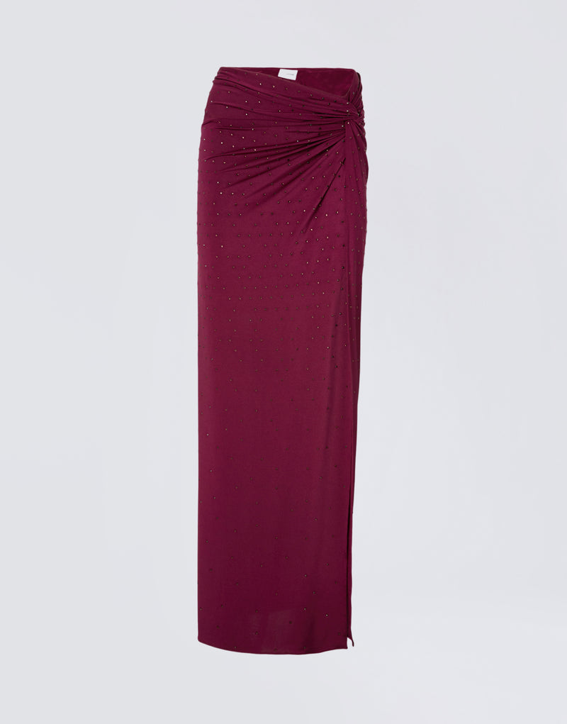 
                          Frontal view of the Zohra Crystal Maxi Skirt, a cabernet-red jersey maxi skirt decorated with all-over crystals, featuring side knot draping and waist ruching.
                        