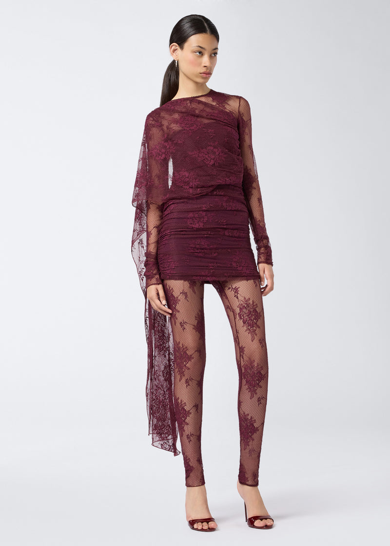 
                          Frontal view of a woman wearing Zillah Leggings in cabernet lace, featuring a sheer mid-rise waist, solid trim, and full-length legs extending to the ankles.
                        