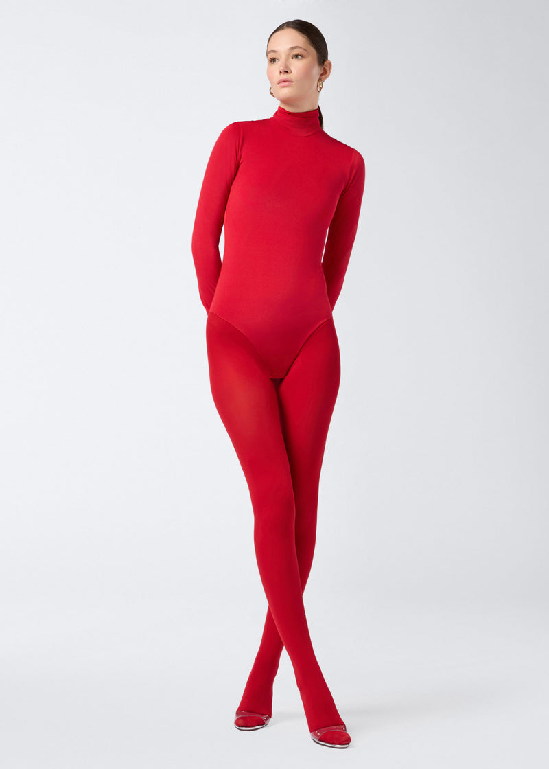 
                          Frontal view of model wearing the Ziggy Bodysuit, a fitted red jersey women&#39;s bodysuit with long sleeves, turtleneck, and zip fastening at the back.
                        