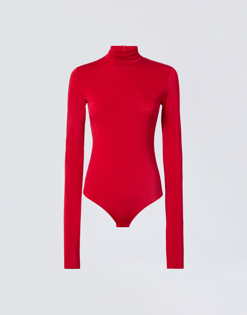 
                          Frontal view shows Ziggy Bodysuit in vibrant red lightweight jersey, featuring a turtleneck, long sleeves, and fitted silhouette on plain background.
                        