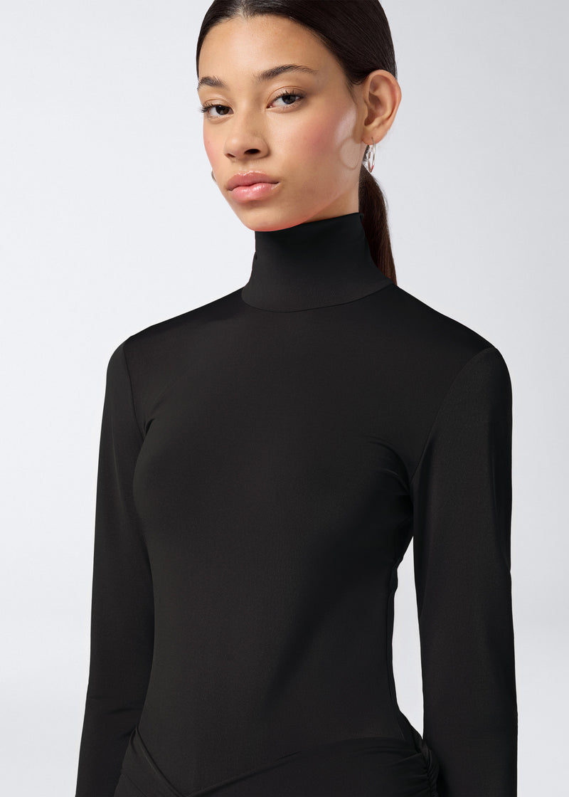 
                          Frontal view shows a model wearing the Ziggy Bodysuit in black lightweight jersey, featuring long sleeves and a sleek turtleneck.
                        