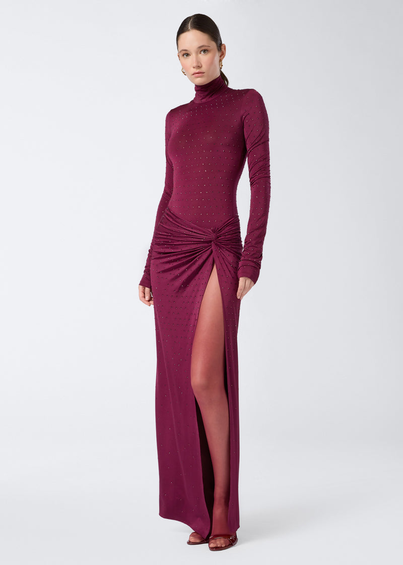 
                          Frontal view shows a woman wearing the Ziggy Bodysuit in cabernet color, featuring long sleeves, a turtleneck, and all-over crystal embellishments.
                        