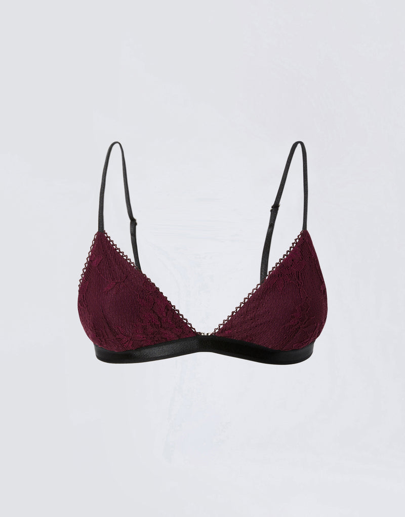 
                          Frontal view of the New Guenda Bra, featuring cabernet-colored lace cups, black band under the bust, micro lace trim, and adjustable black straps.
                        