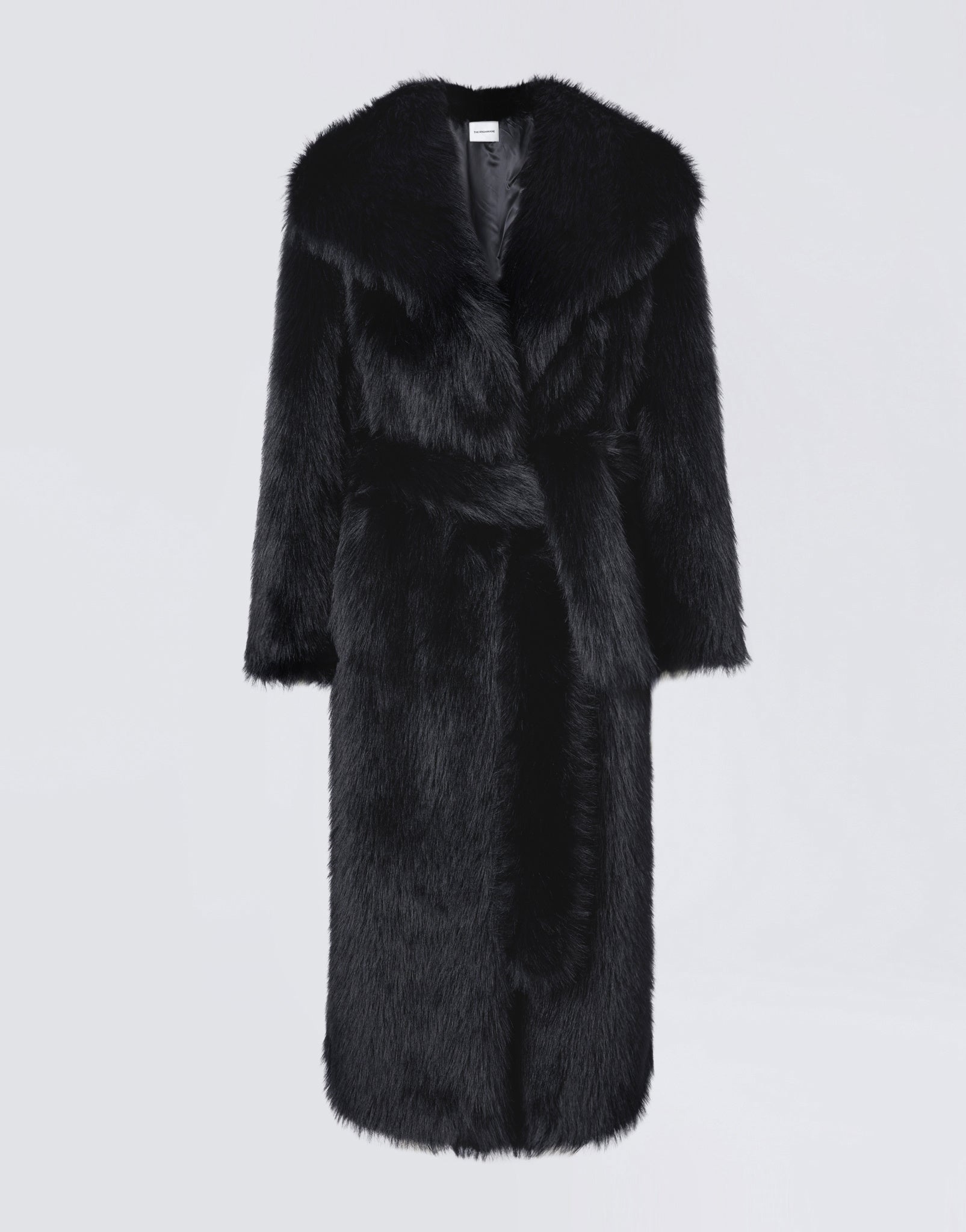 Frontal view of the Winter Maxi Coat, a black faux fur coat for women with a large shawl lapel collar, matching waist belt, and long sleeves.