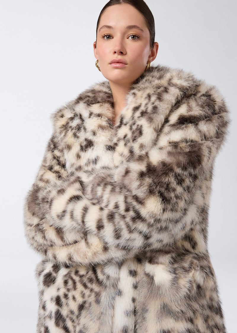 
                          Frontal view of a woman wearing the Weston Maxi Jacket, an animal-print faux fur jacket with notched lapel, padded shoulders, and long sleeves.
                        