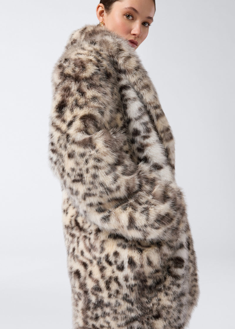 
                          Side view of a woman wearing the Weston Maxi Jacket, an animal-print faux fur coat with padded shoulders, notched lapel, long sleeves, and welt pockets.
                        