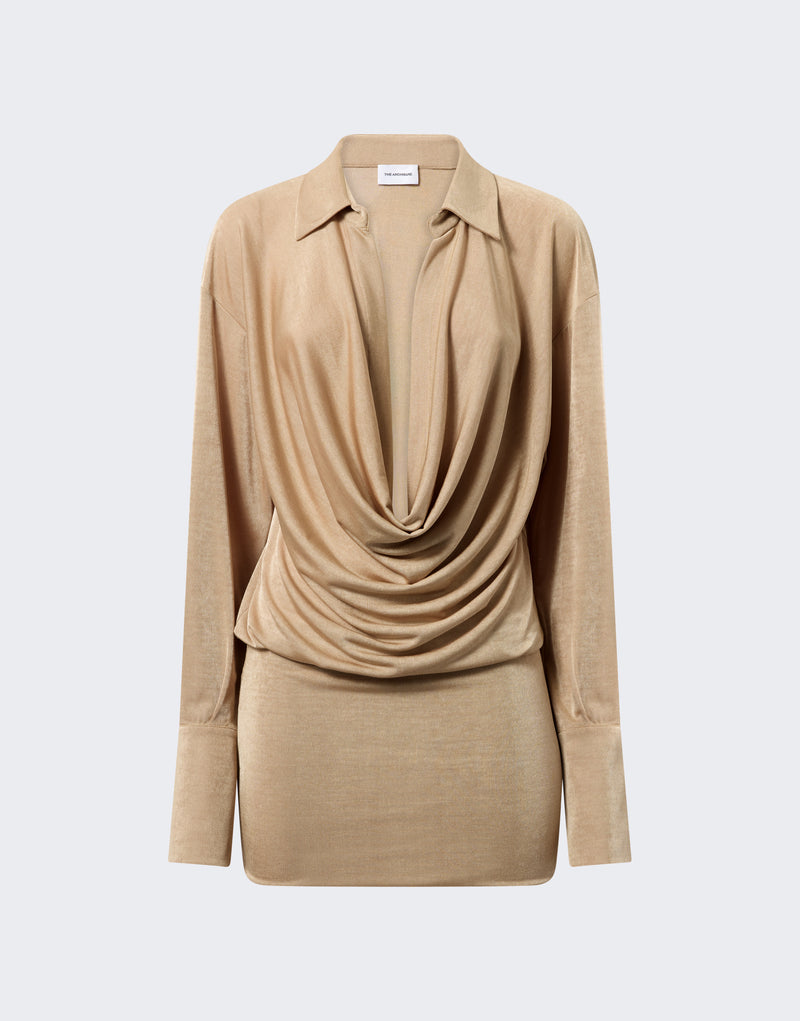 Frontal view — Lilia Mini Dress: golden jersey mini dress draped into a deep plunging V-neck with a pointed spread collar, long exaggerated buttoned cuffs, and softly ruched waist on neutral background.