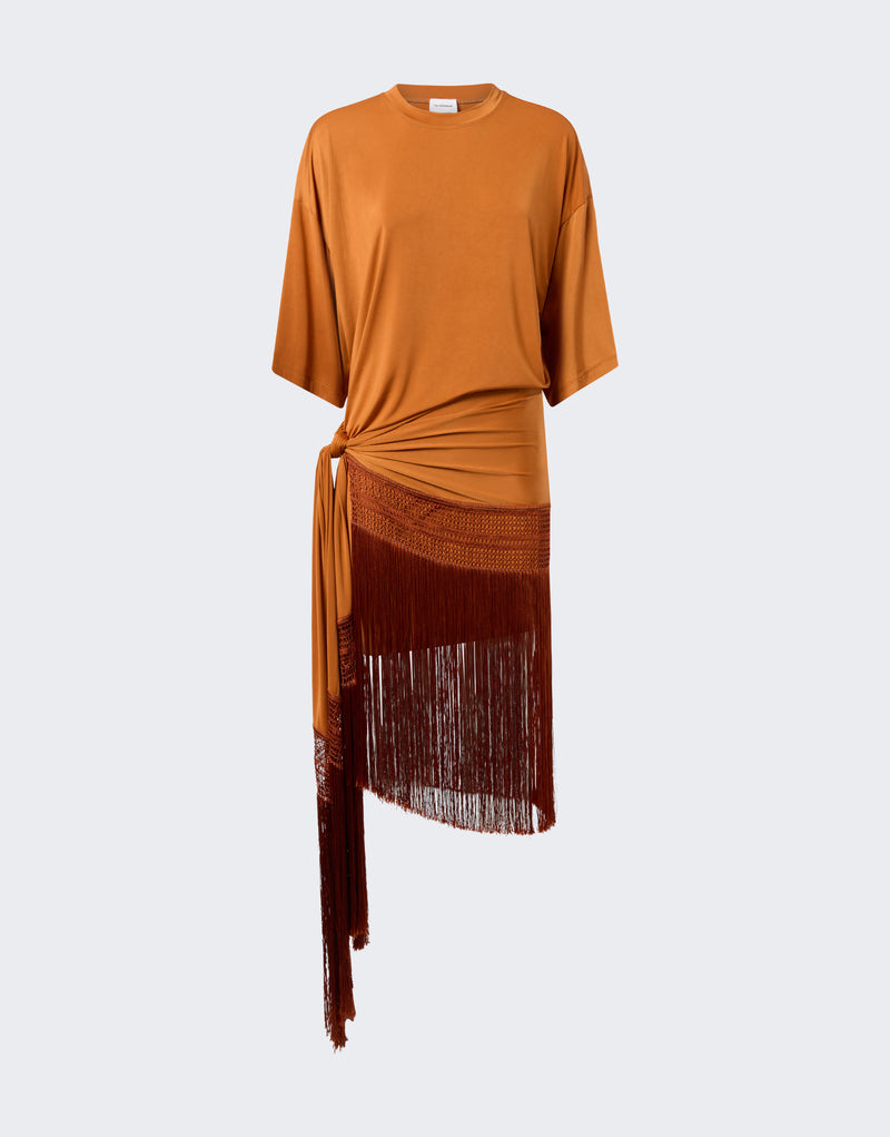 Frontal view — Azul Midi Dress shown on neutral background; burnt-orange T-shirt silhouette with crew neck and butterfly sleeves, knotted at left hip with long macramé fringe cascading asymmetrically.