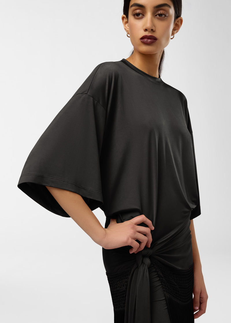 Frontal view of Azul Midi Dress on model, showing crew neck, wide butterfly sleeves, side gather knot cinching waist and fringe-trimmed hem.