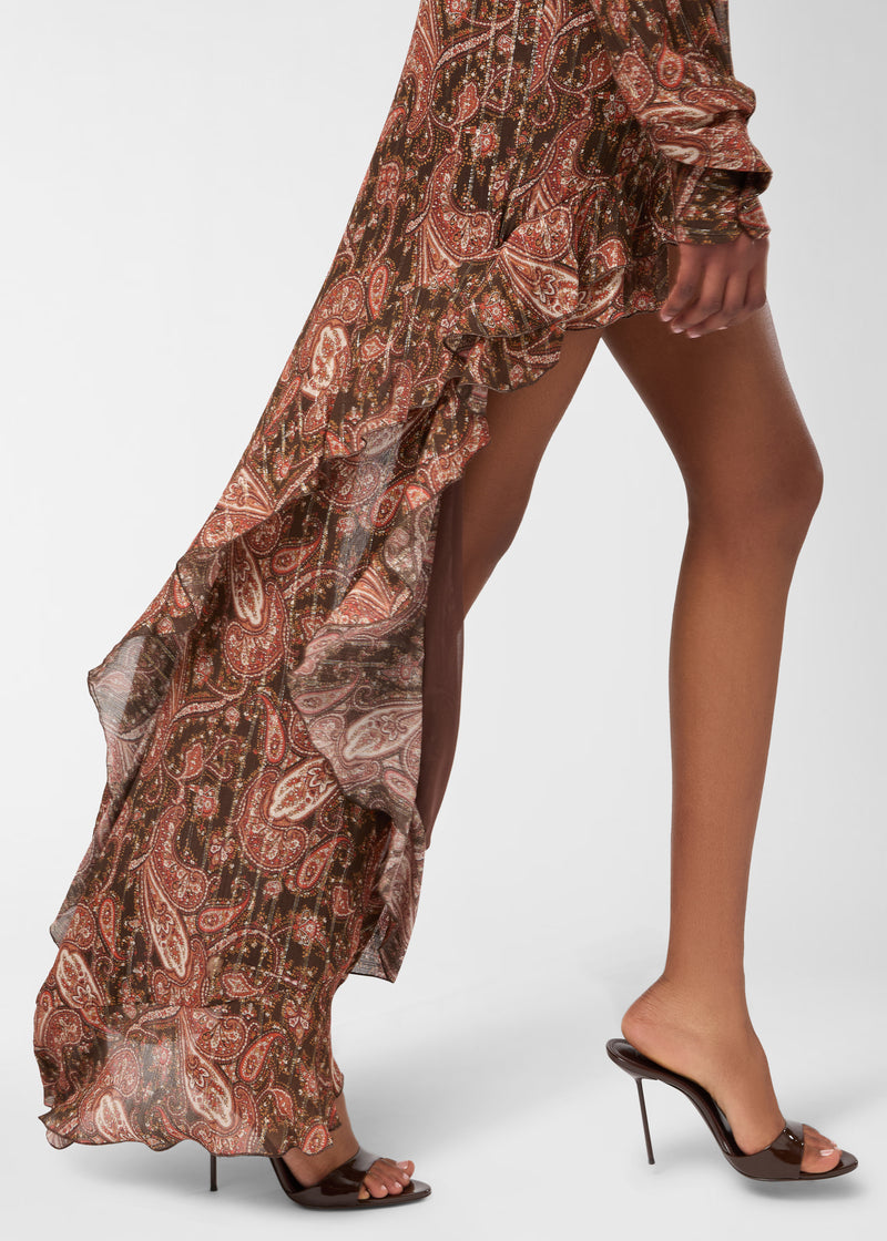 Side view — Camelia Maxi Skirt: paisley georgette skirt cascades asymmetrically with ruffled trim and high slit, draping to the floor as model steps forward in heeled mules.