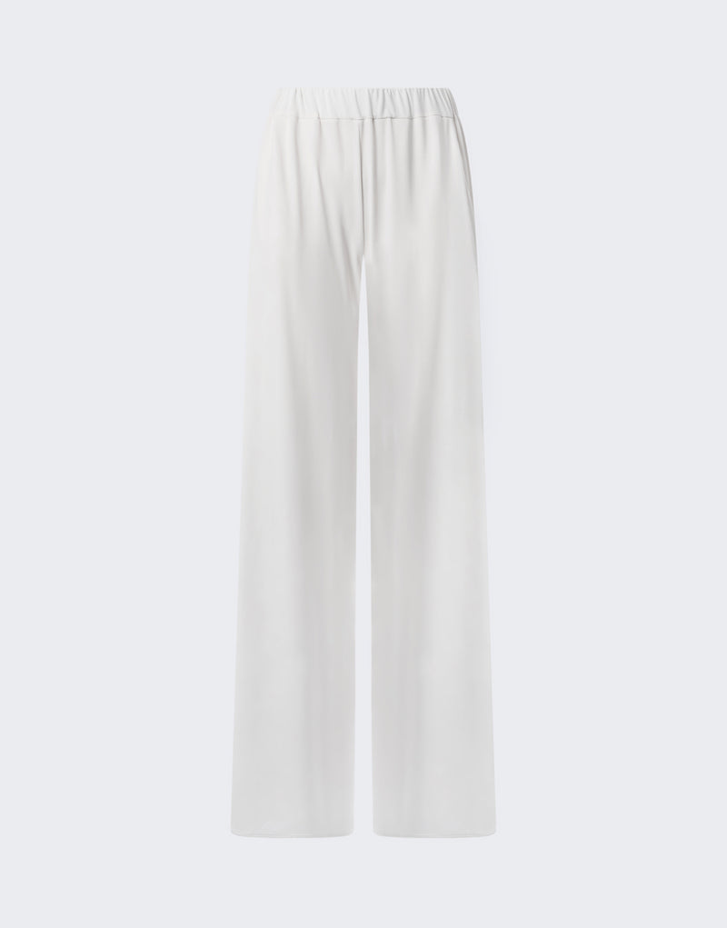 Frontal view: Lana Pants — off-white wide-leg jersey pants shown flat, highlighting high-rise elasticated waistband, concealed side slit pockets, and long floor-grazing hem on pale background.