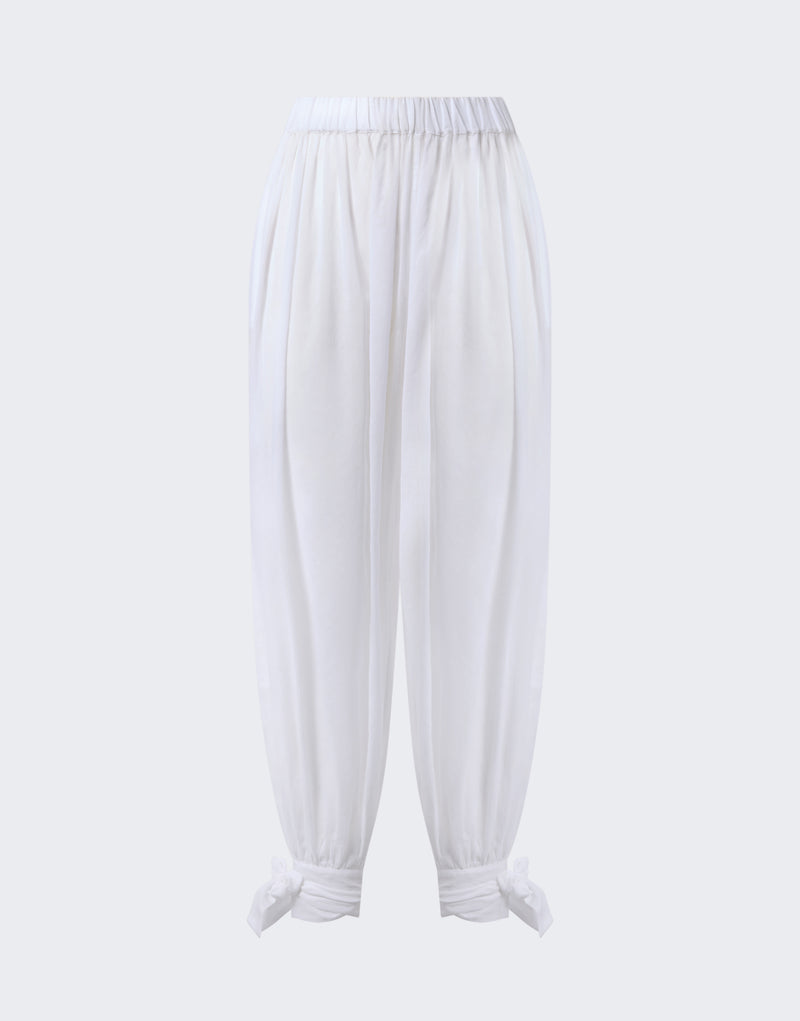 Frontal view: Noor Maxi Pants shown, white cotton muslin with low-rise elastic waistband, wide balloon legs tapered at ankles and tied into bows on light-gray background.
