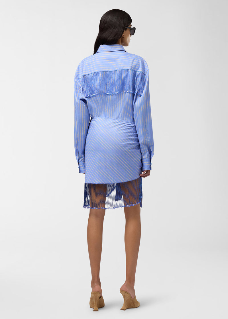 Rear view: Miley Shirt worn by model against plain studio background, showing light-blue and saffron maxi stripes, bejeweled fringe along shoulder and back yoke, pointed collar.