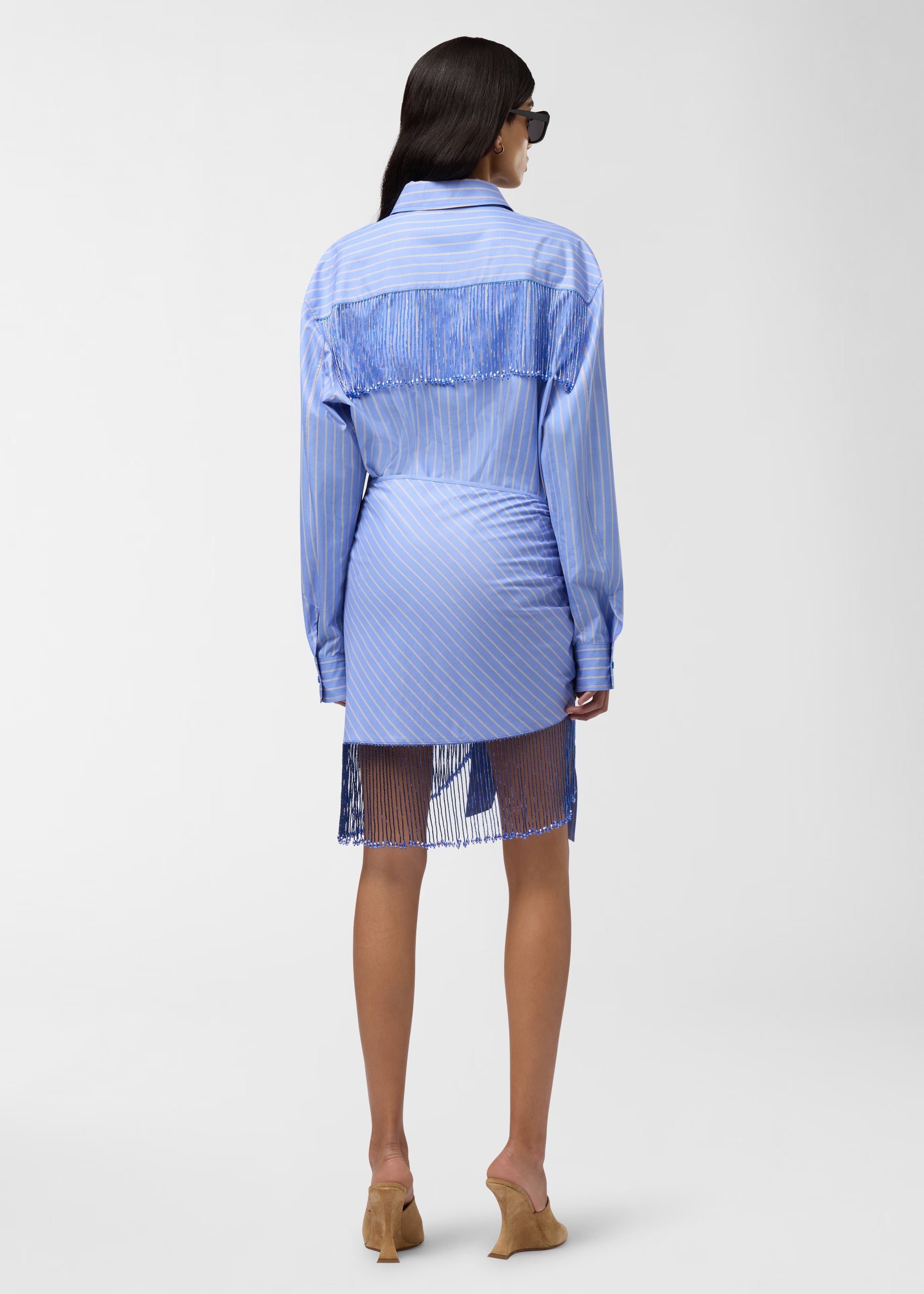 Rear view: Miley Shirt worn by model against plain studio background, showing light-blue and saffron maxi stripes, bejeweled fringe along shoulder and back yoke, pointed collar.