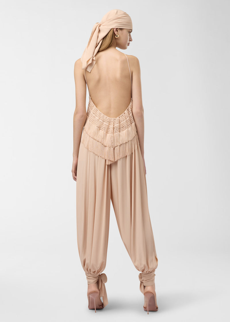 Rear view — Reina Top: model wears a peach crepe de chine bandeau with thin halter tiebacks, openwork stitching and multi-layered fringe, against a studio background.