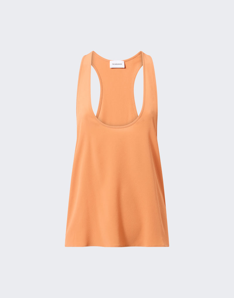 Frontal view: Pura Top displayed flat against a pale grey background, showing scooped neckline and racerback, tangerine crepe de chine flowing down the bodice. Visible label: "THE ANDAMANE".